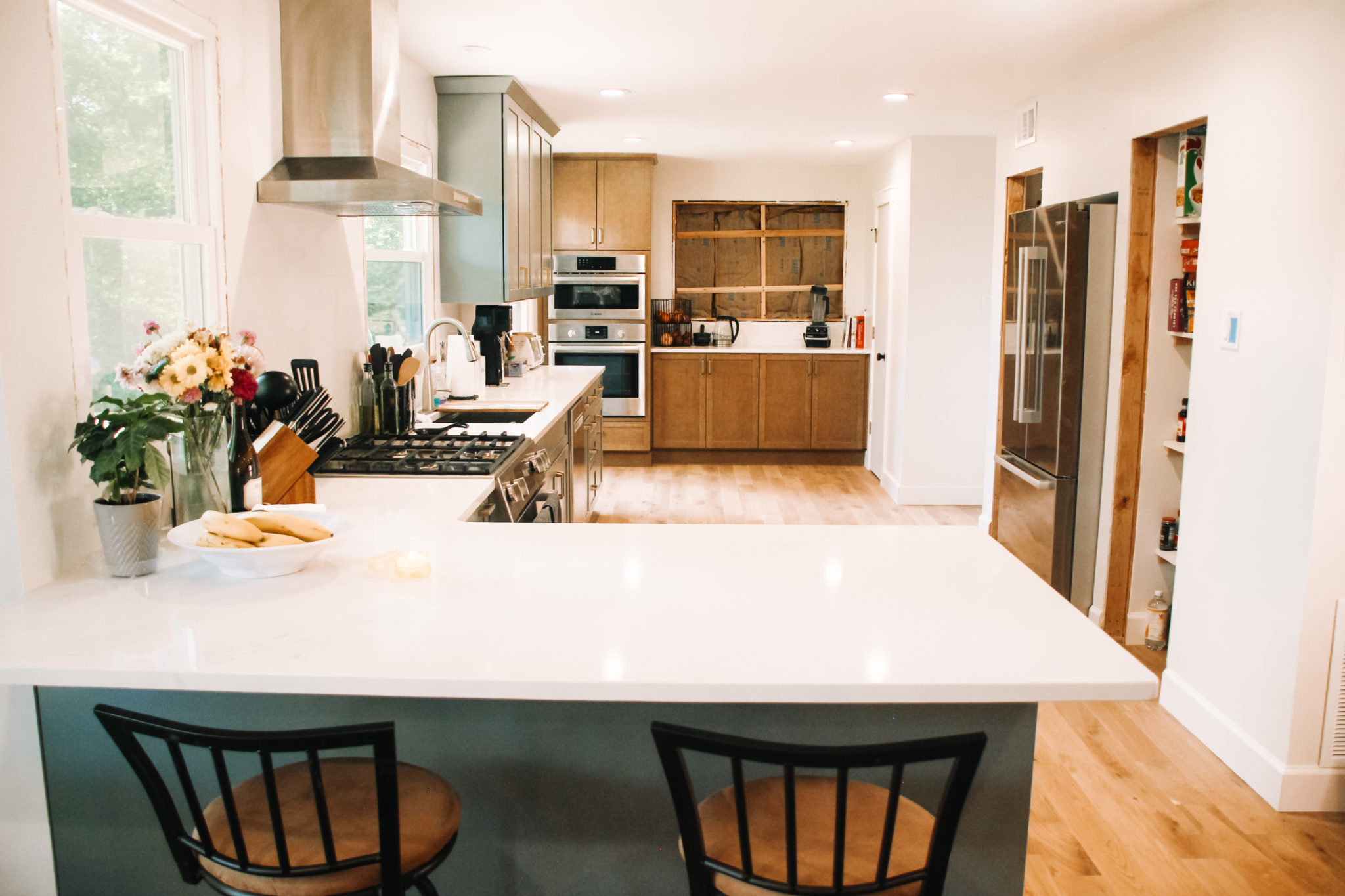 Light green kitchen with white quartz