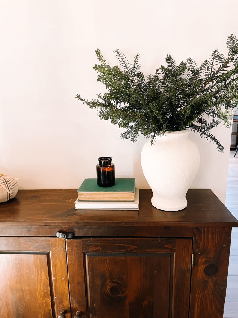 a vase that's been painted with paint and baking soda for a clay effect