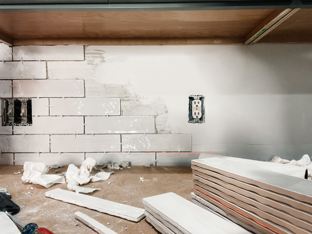 White subway tile being installed on backsplash