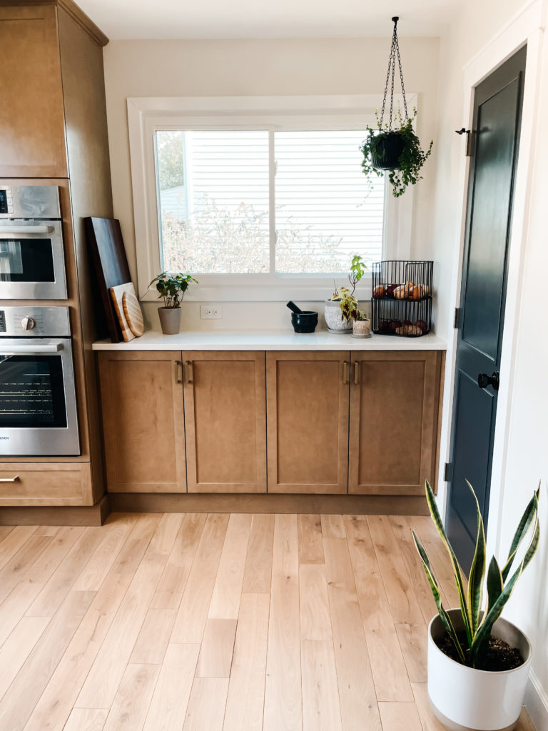 wood kitchen with black and plants door trim